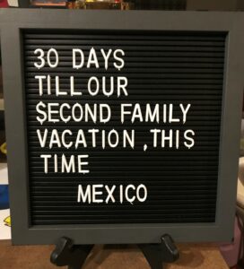 A letter board saying how many more days until we go on vacation, and how many more days I've got to achieve my goal.